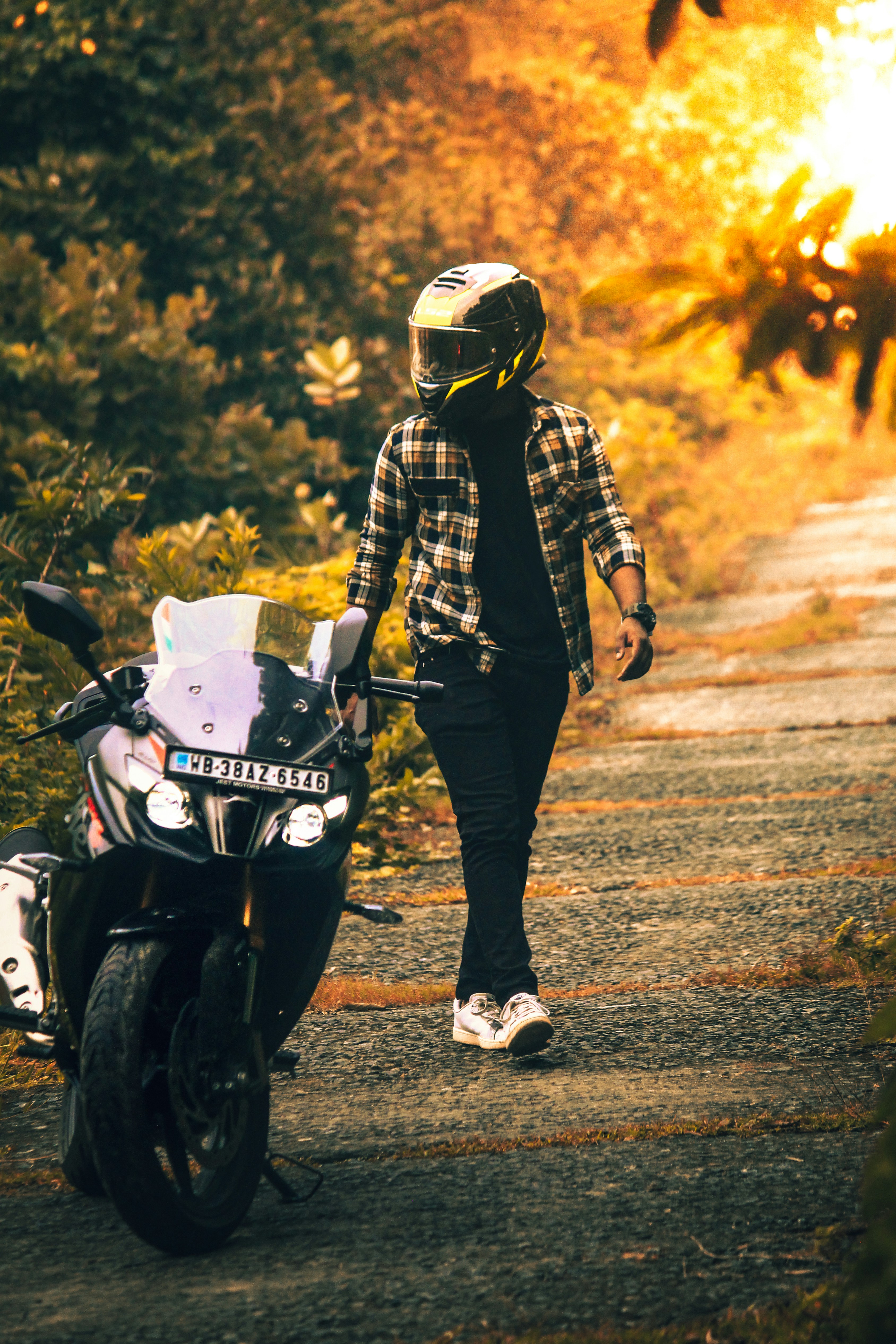 A person walking down a path next to a motorcycle photo – Free ...