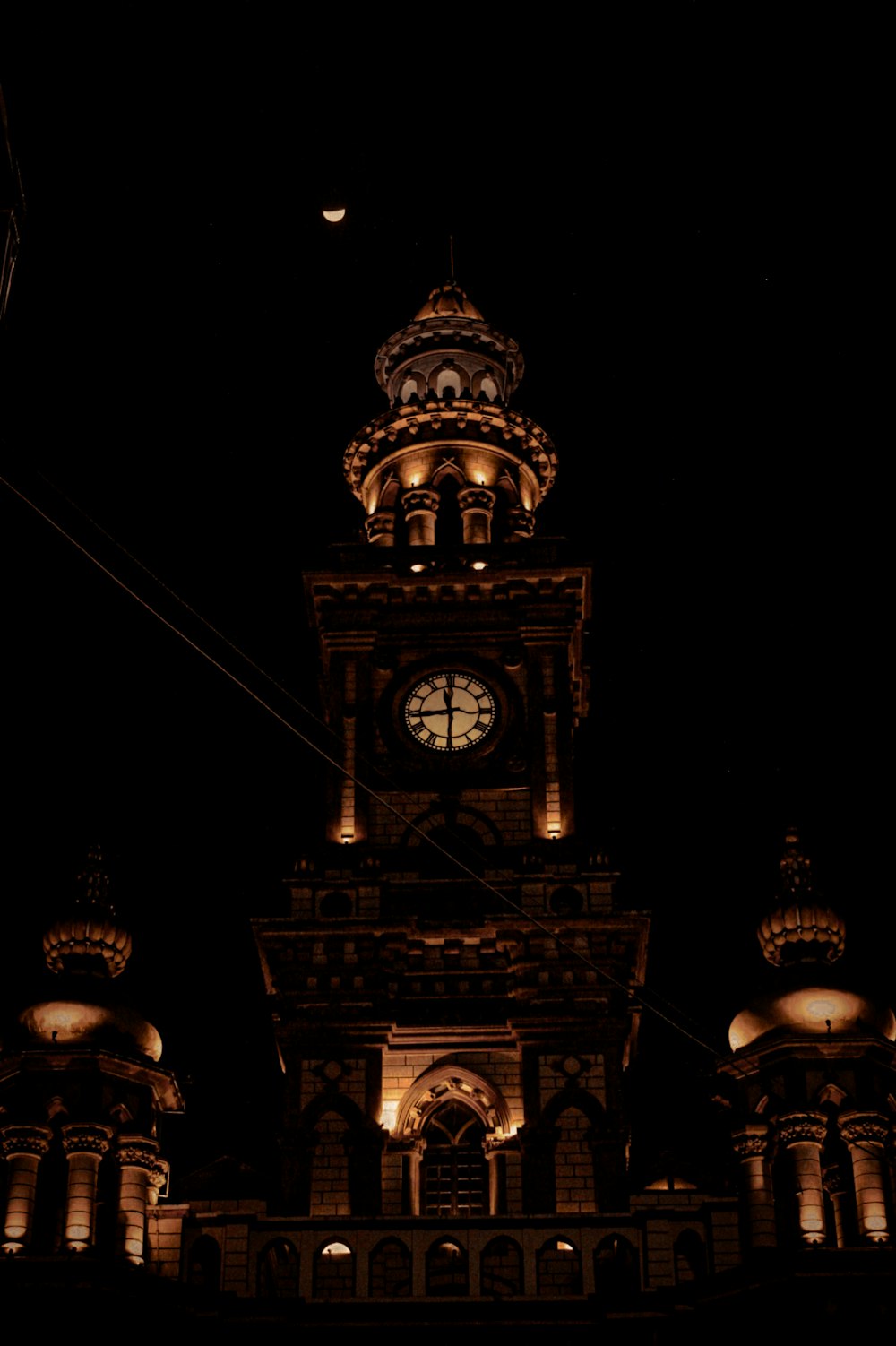 a large clock tower lit up at night