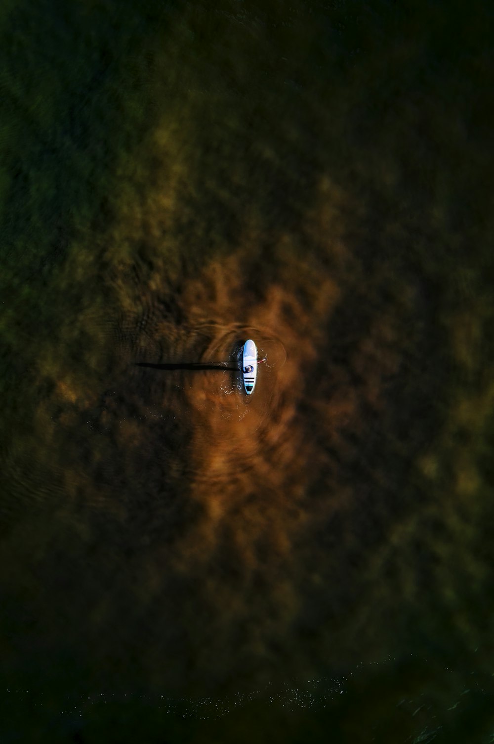 a small boat floating on top of a body of water