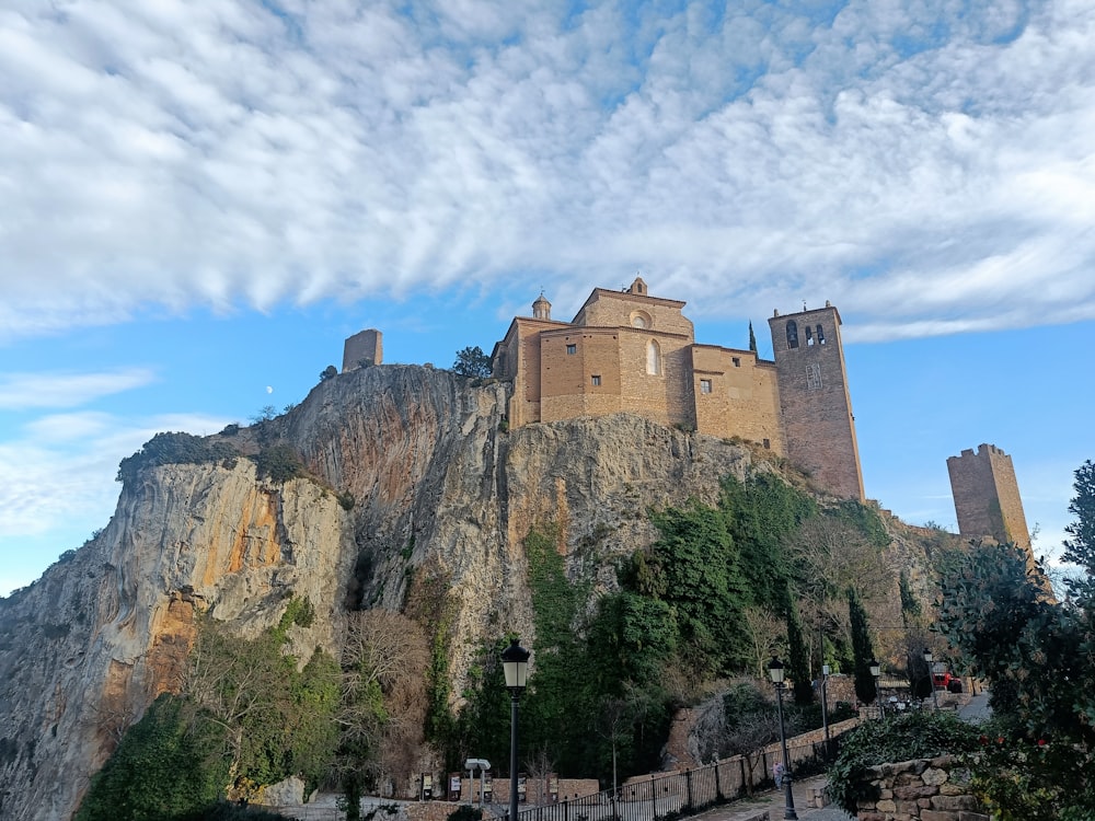 a castle on top of a mountain with a sky background