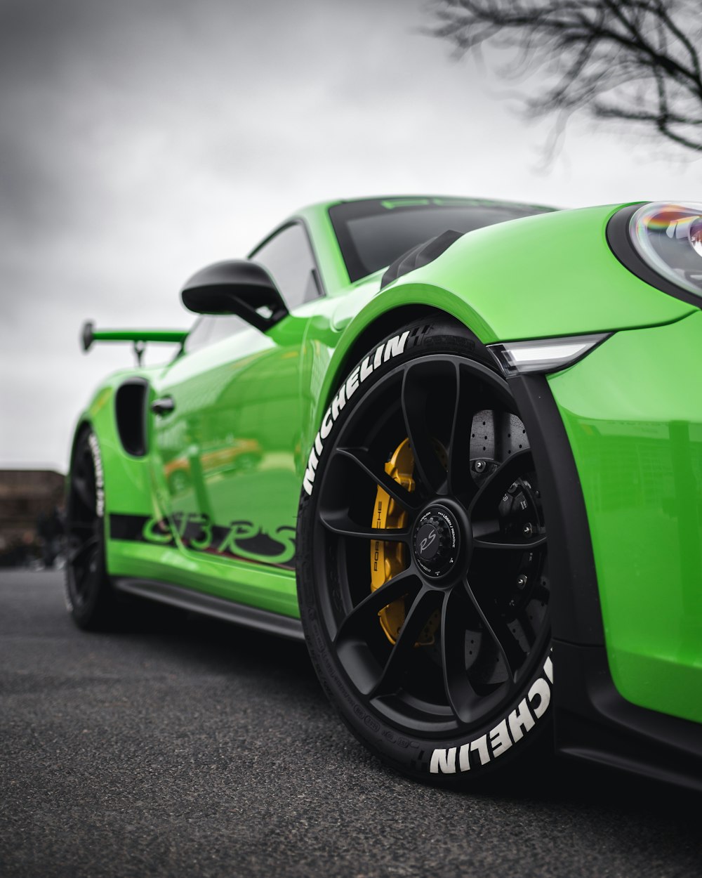 a green sports car parked in a parking lot