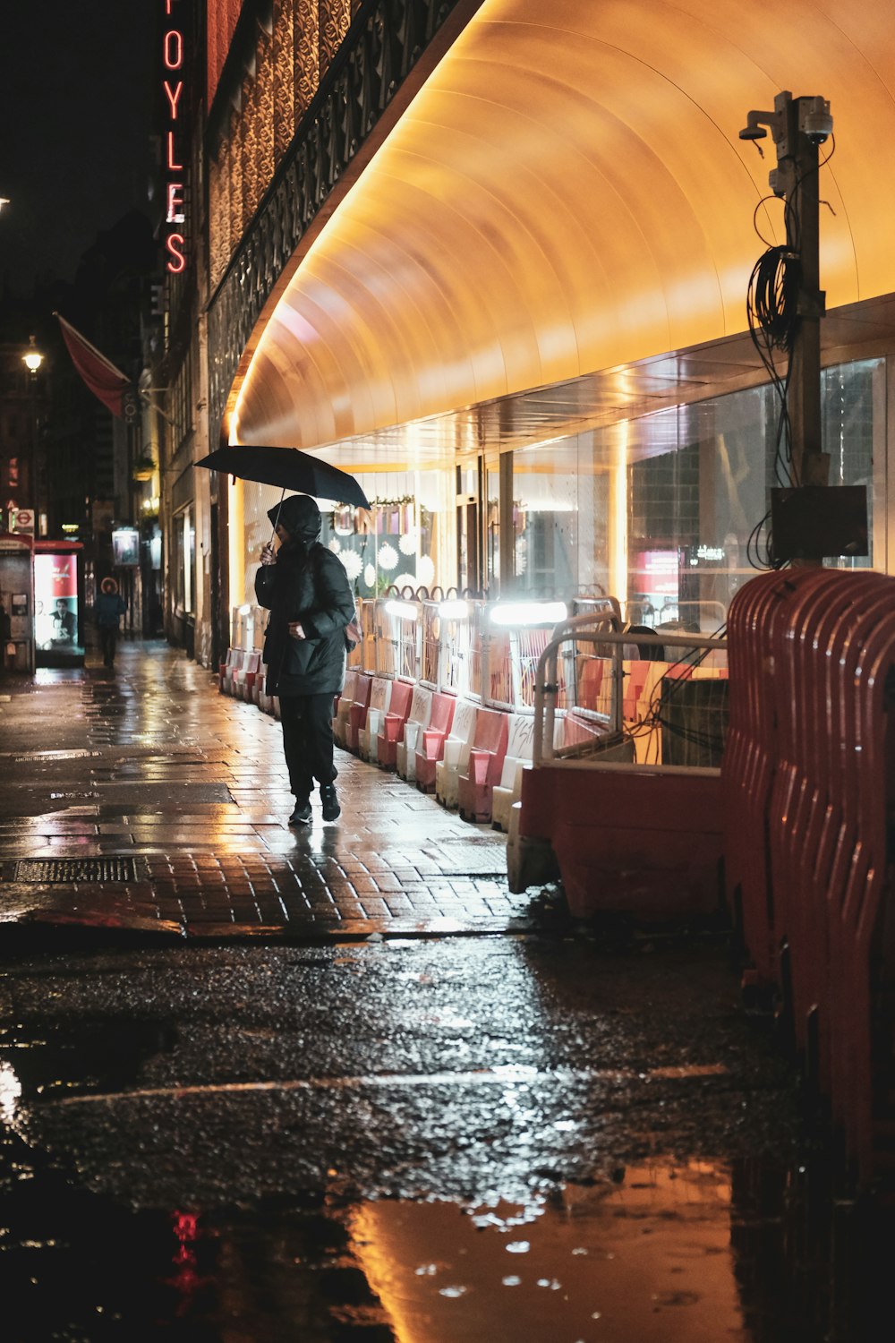 a person walking down a street holding an umbrella