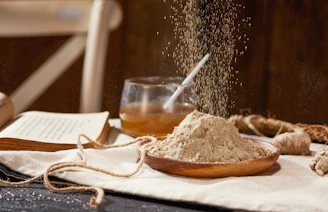 a table topped with a wooden bowl filled with sand