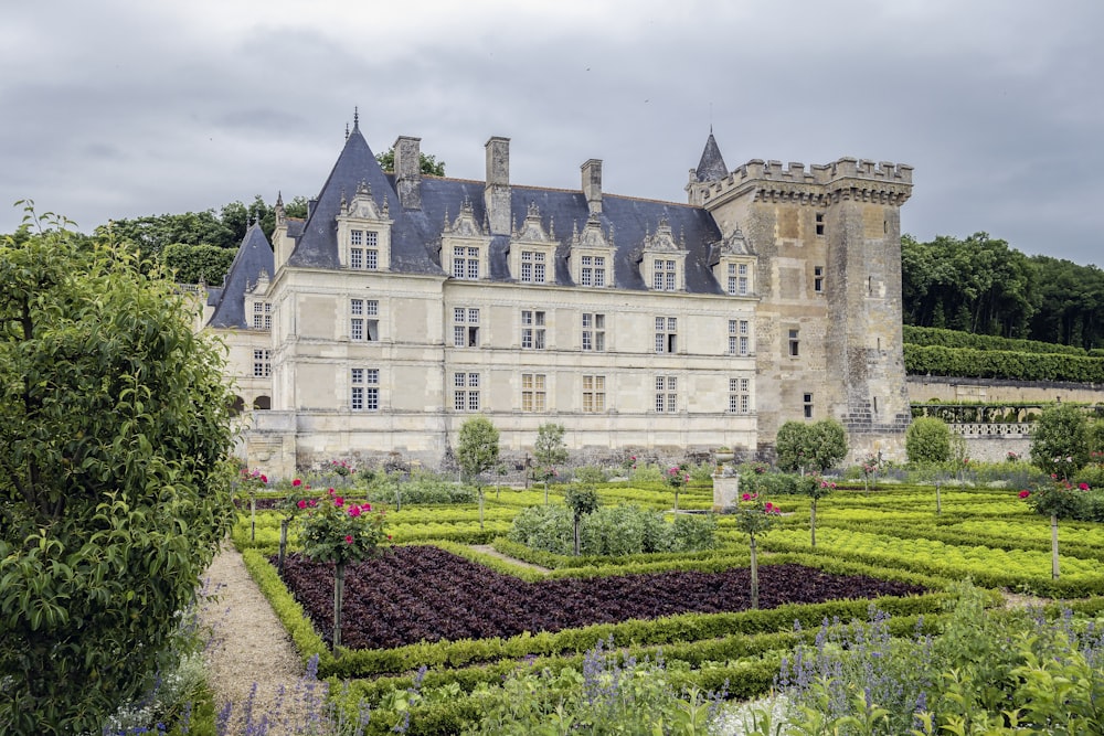 a castle with a garden in front of it