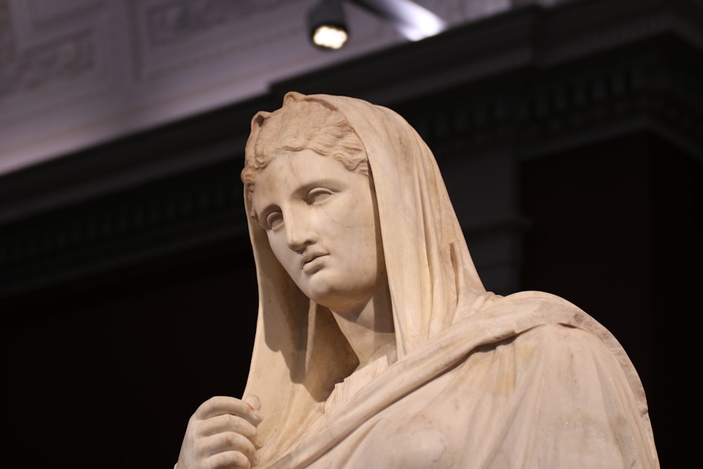 a statue of a woman with a veil on her head