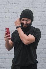 a man with a beard is talking on a cell phone