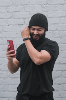 a man with a beard is talking on a cell phone