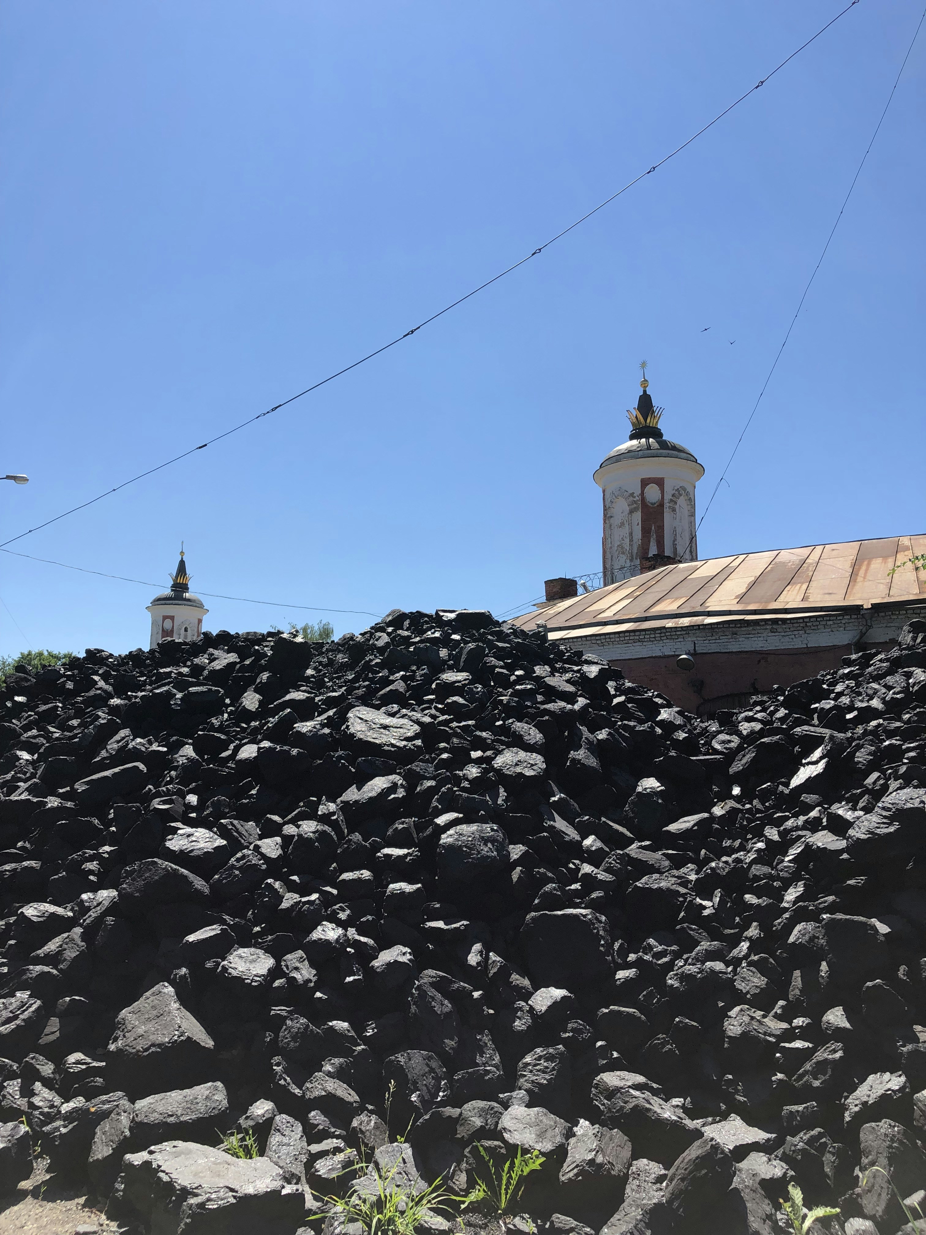 a large pile of rocks with a clock tower in the background