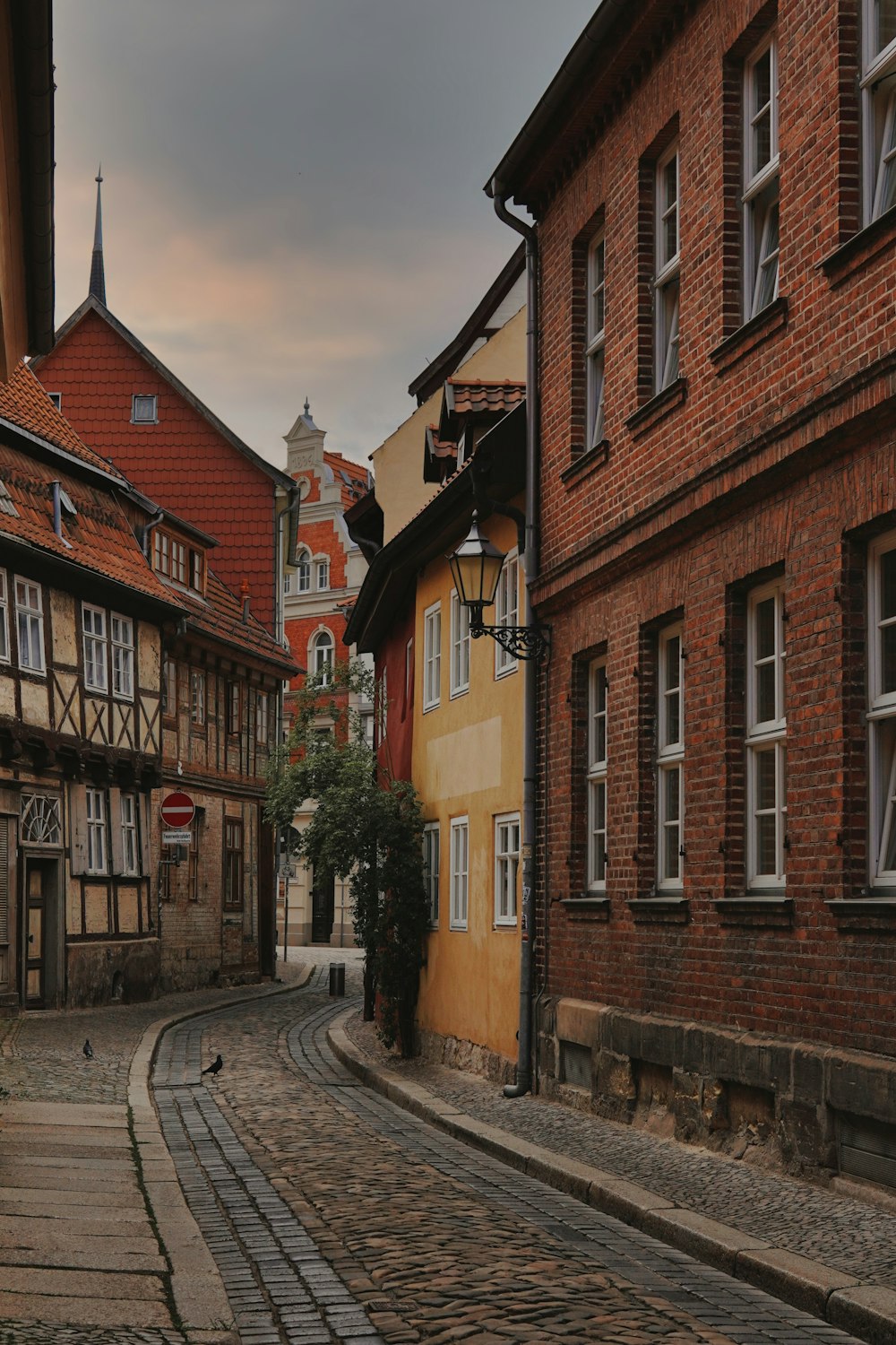 a cobblestone street lined with old buildings