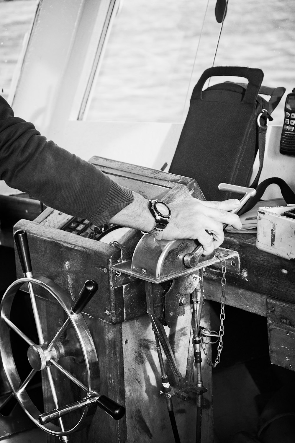 a black and white photo of a man on a boat