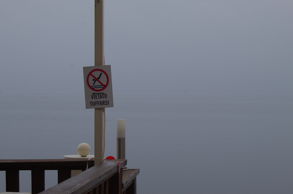a sign on a pole on a foggy day