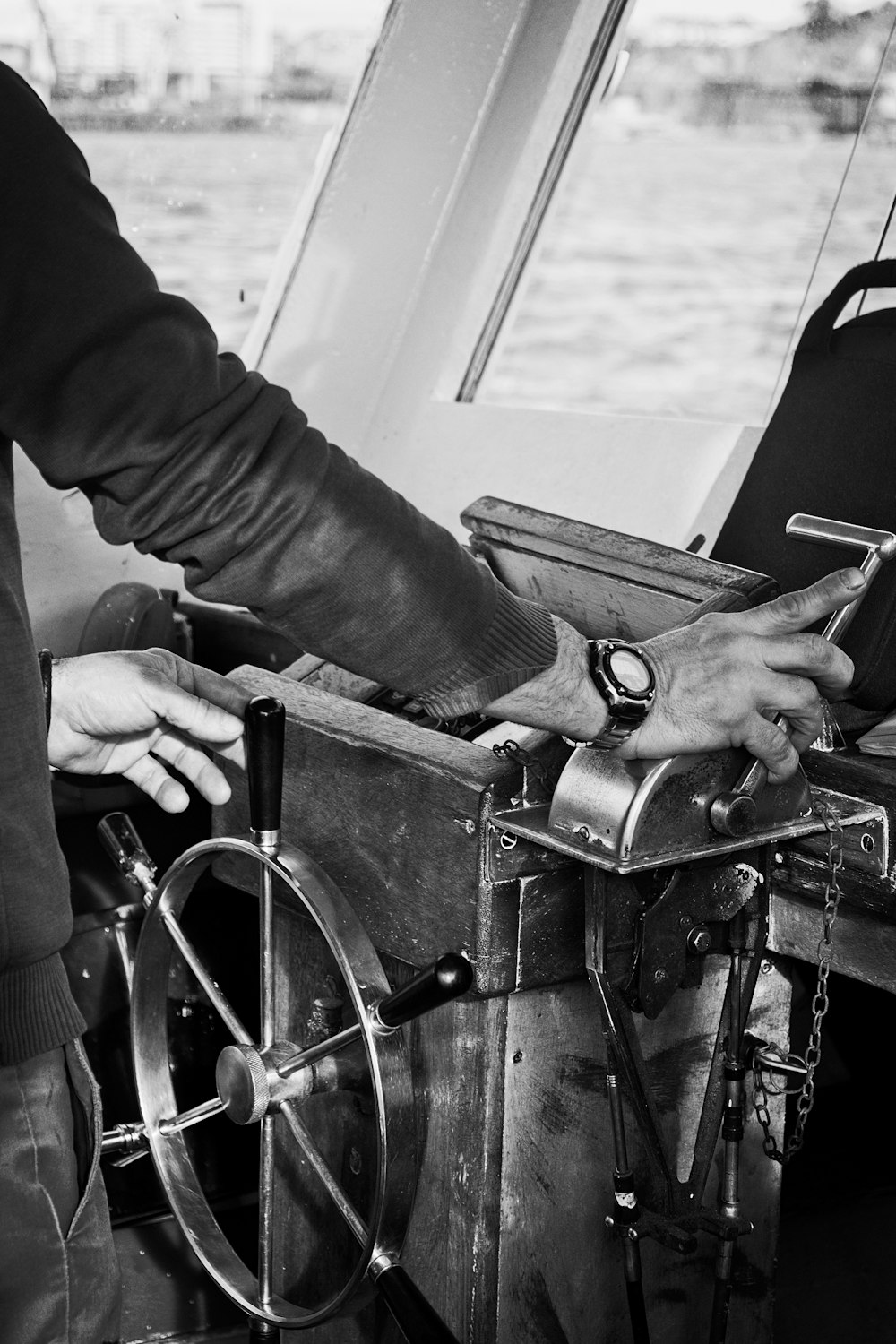 a black and white photo of a person on a boat