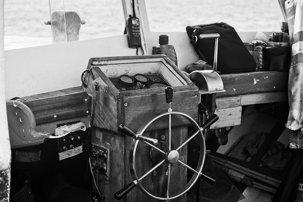 a black and white photo of a boat steering wheel