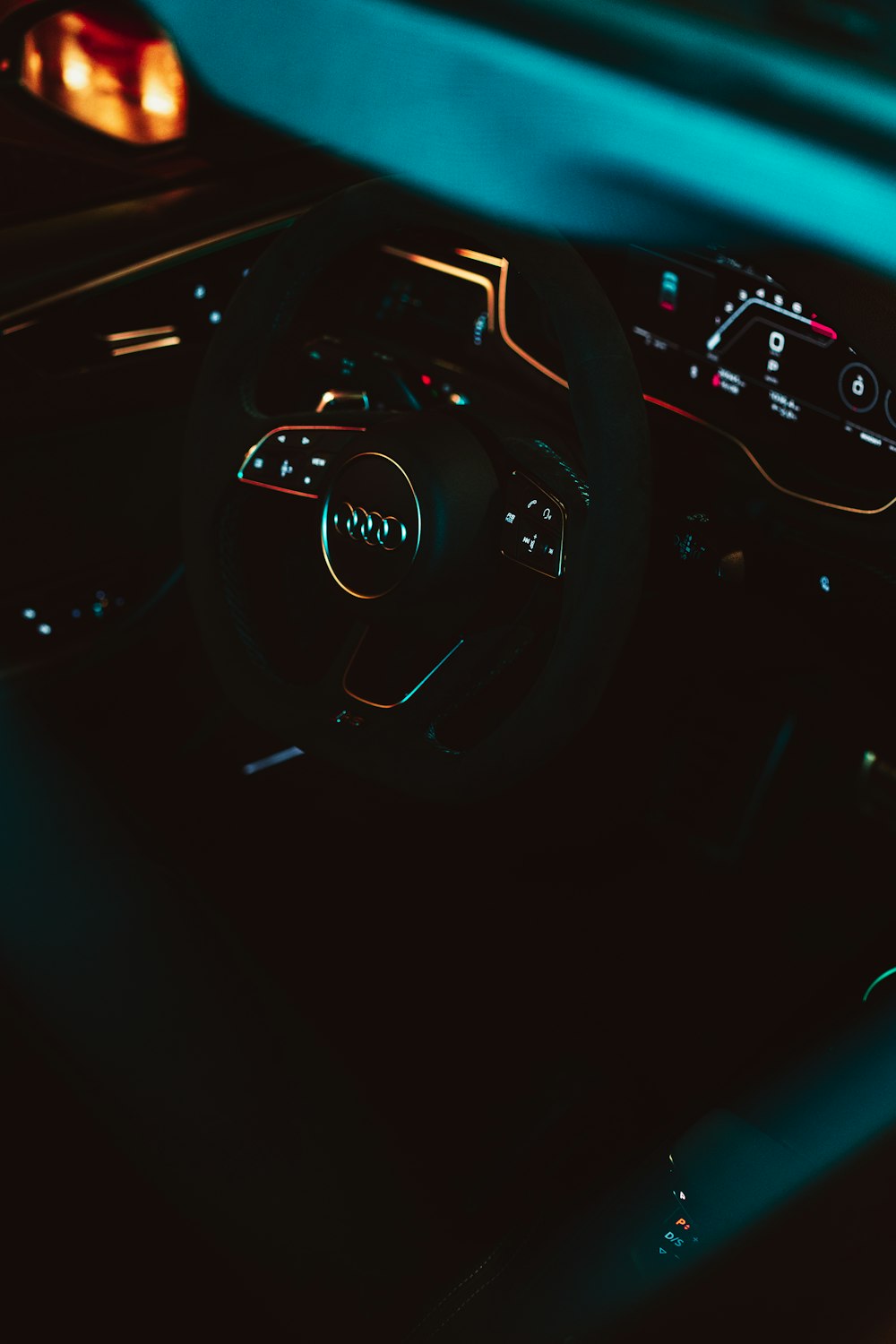 a car dashboard with a steering wheel and dashboard lights