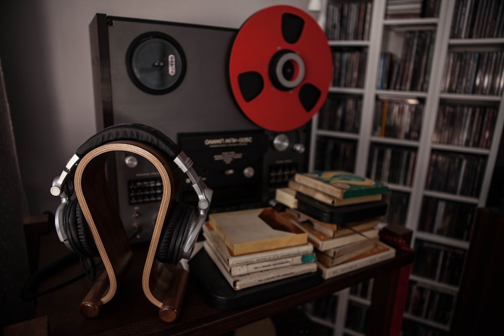 a table with a bunch of books and headphones on it