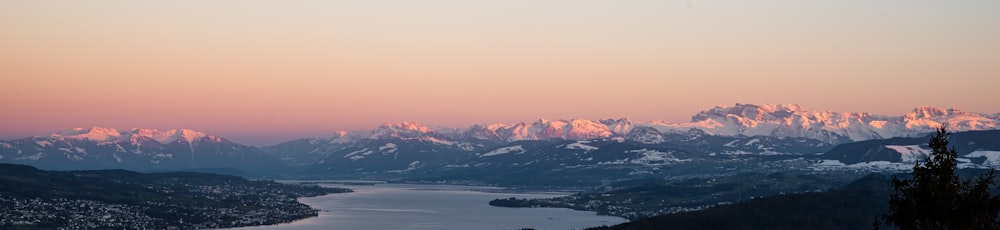 a view of a mountain range with a lake in the foreground