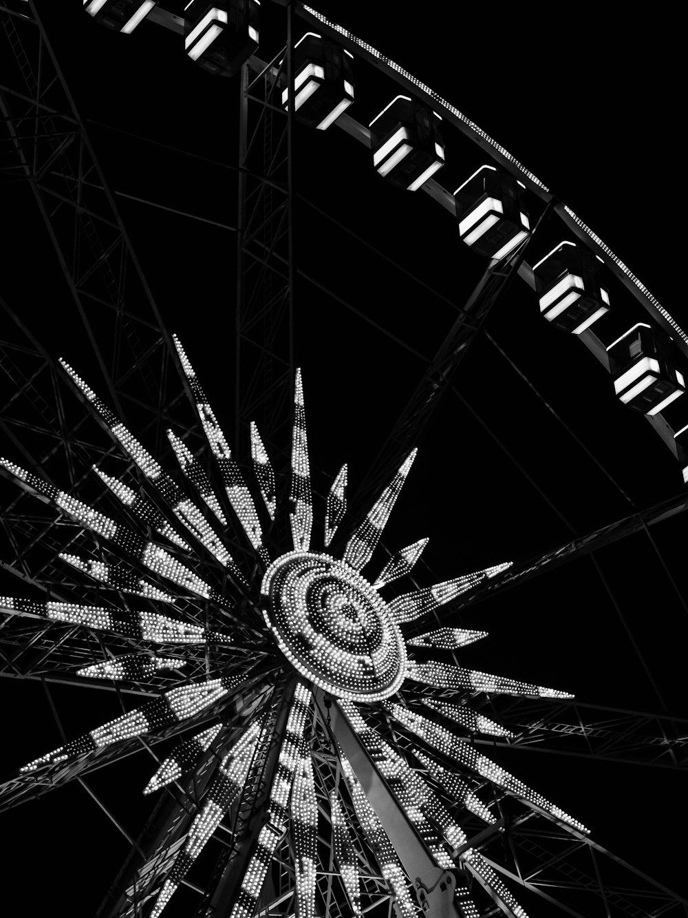 a black and white photo of a ferris wheel