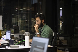 a man sitting in front of a laptop computer