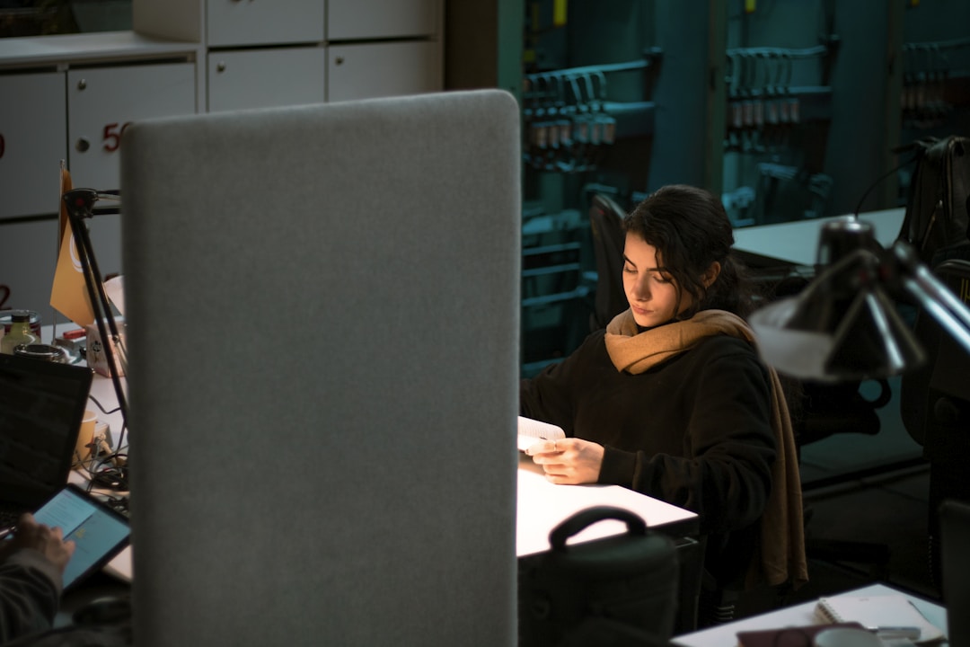 A female professional using online fax services to send client documents while ensuring compliance and security.