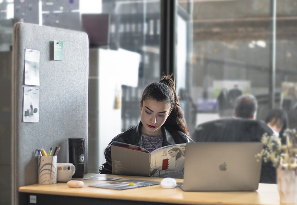 a woman sitting at a table with a laptop