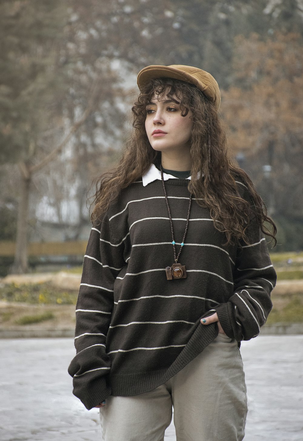 a woman wearing a hat and a sweater