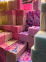 A collection of colorful soap bars arranged on a sandy beach.
