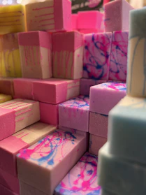 Close-up of pistachio colored soap bars stacked with delicate pastel pink accents.