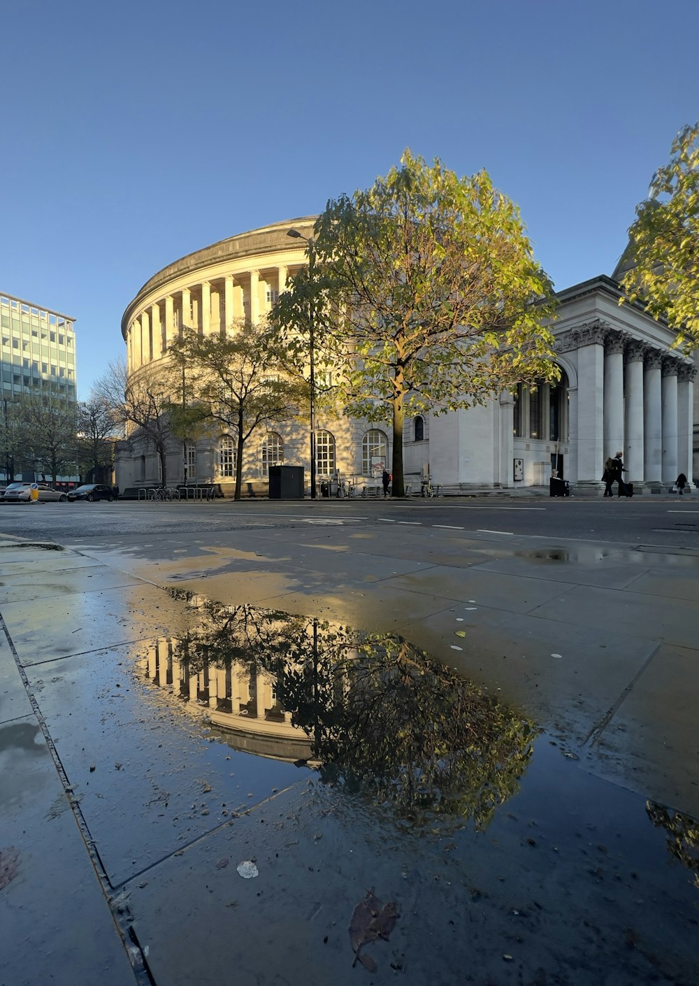 a puddle of water in front of a building