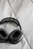 Close-up of stylish over-ear headphones with cushioned ear pads resting on a desk.