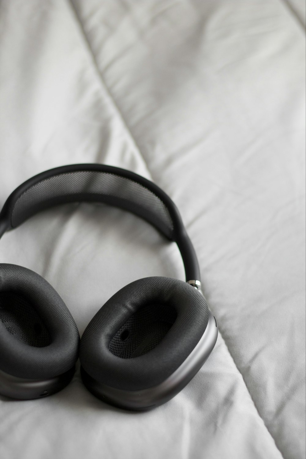 a pair of headphones laying on a bed