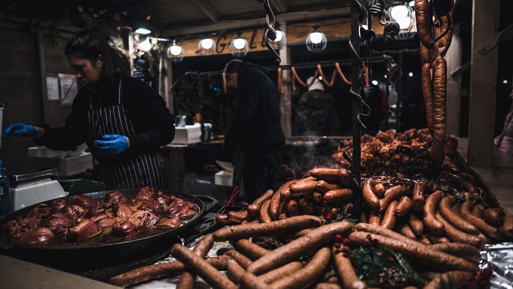 a man standing in front of a table filled with food