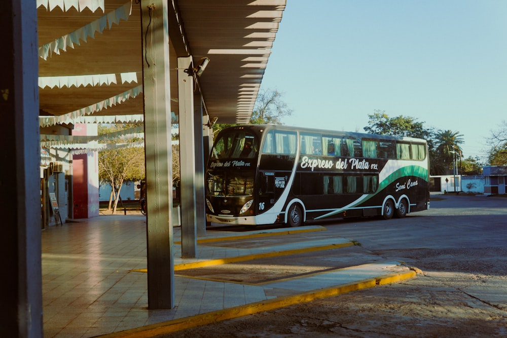 a double decker bus parked at a bus stop