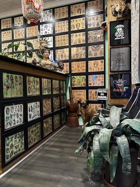 A cozy tattoo studio interior with vibrant artwork on the walls and a welcoming atmosphere.