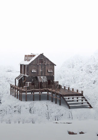 A wooden house stands on stilts surrounded by a snowy landscape, with snow-covered trees in the background. The architecture is rustic, with metal roofing and a sloped walkway leading to the entrance.