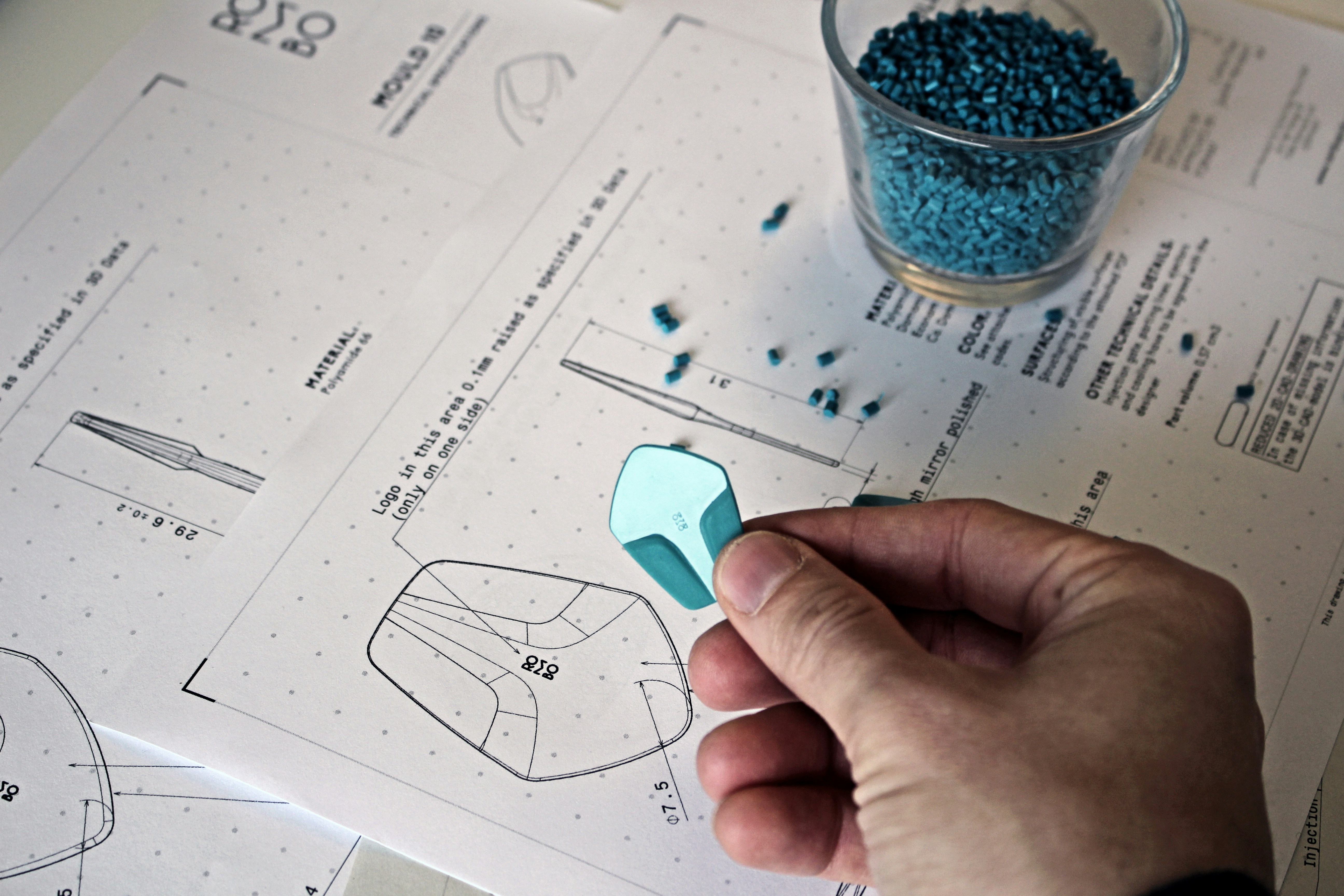 a person cutting out a piece of paper with scissors