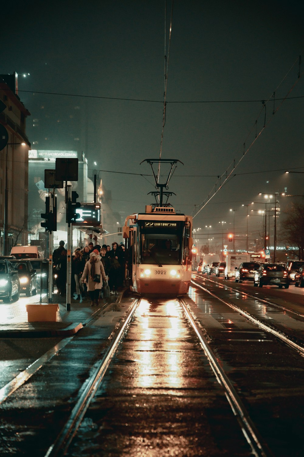 a city bus driving down a street at night