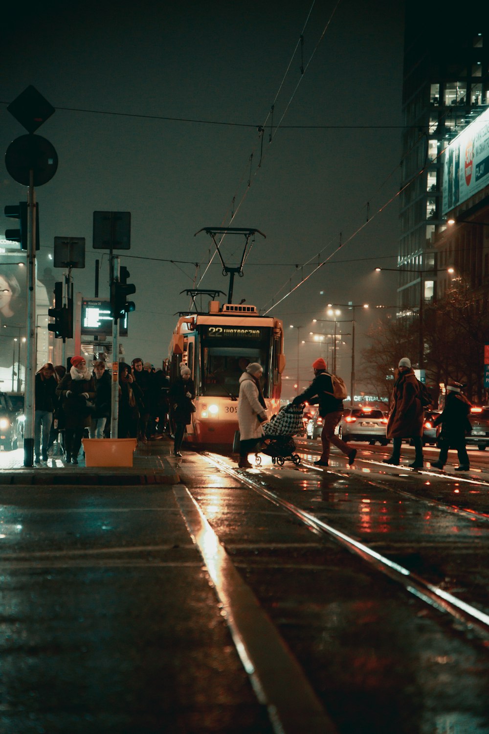 a city street at night with a trolley on the street