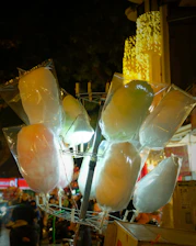 A vibrant cotton candy cart with colorful lights and a hygienic setup at a private party.