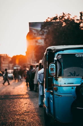 A comfortable taxi parked by the scenic Pondicherry coastline at sunset.