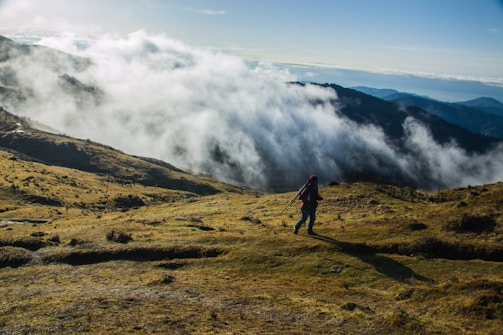 A serene image of a person hiking a mountain trail at sunrise, embodying adventure and self-discovery.