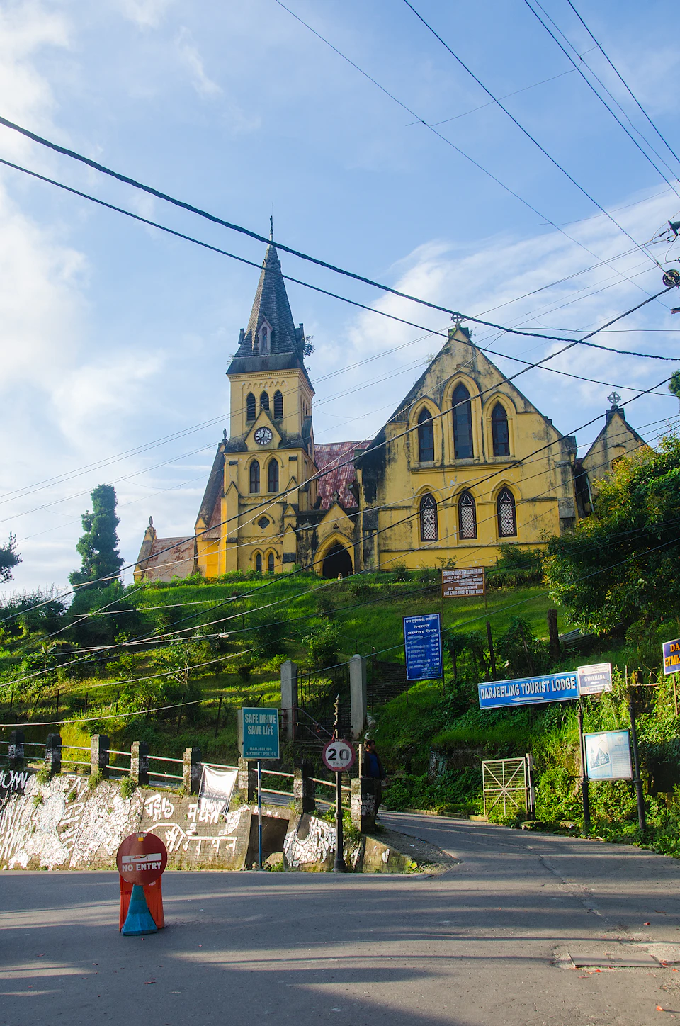The yellow Gothic church of St Andrew's in Darjeeling, its clock set in the tower below the spire
