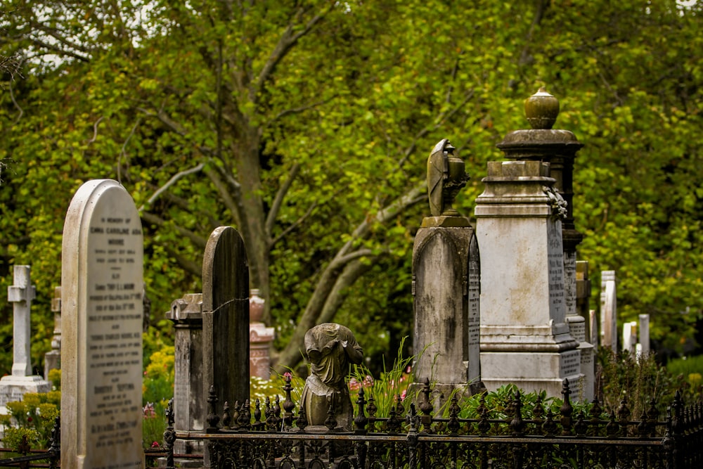 a cemetery with headstones and trees in the background