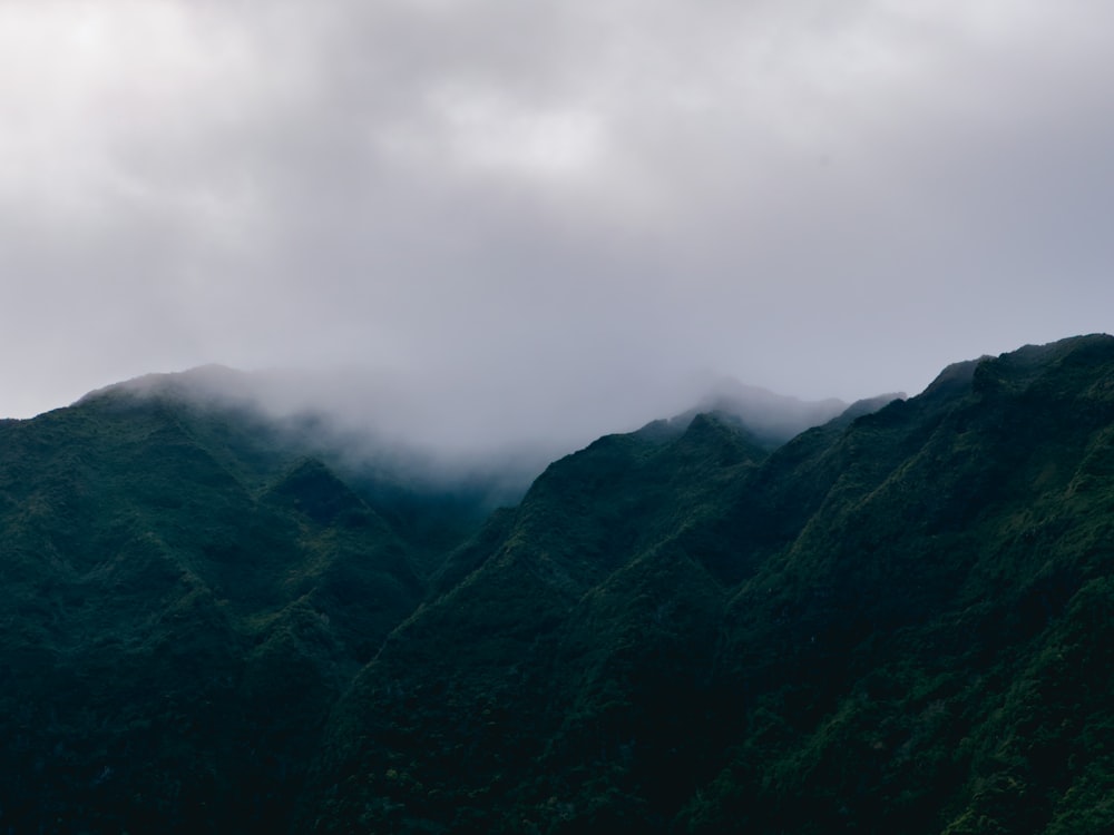 a view of a mountain range with low clouds