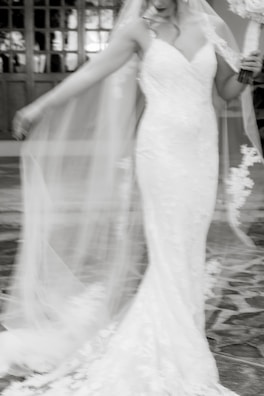Flowing tulle skirt of a wedding dress captured mid-twirl in natural light.
