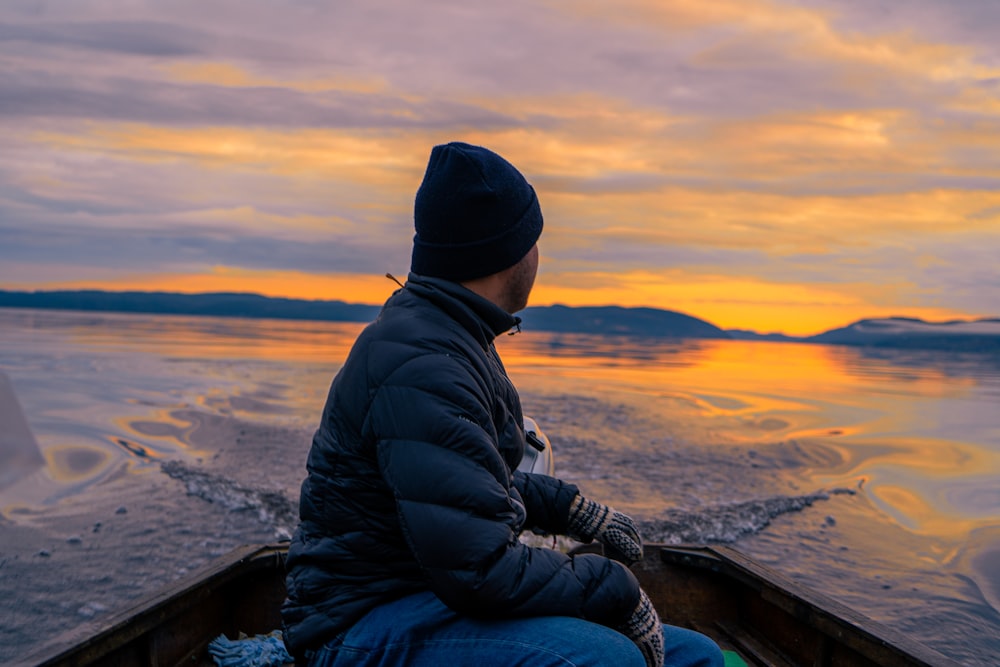 a person sitting in a boat on the water