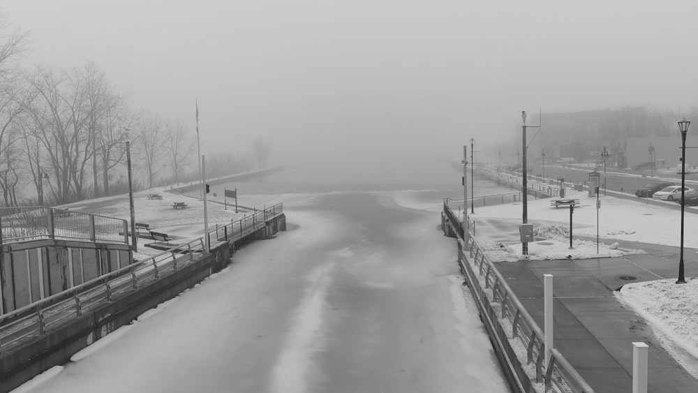 a black and white photo of a snowy street