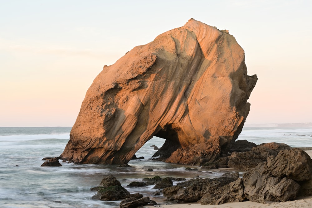 a large rock sticking out of the ocean