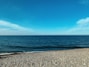 a person standing on a beach next to the ocean