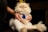 Close-up of a happy cat owner gently holding a Persian cat indoors.