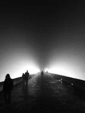Guests entering through a misty fog-filled pathway illuminated by soft lights.